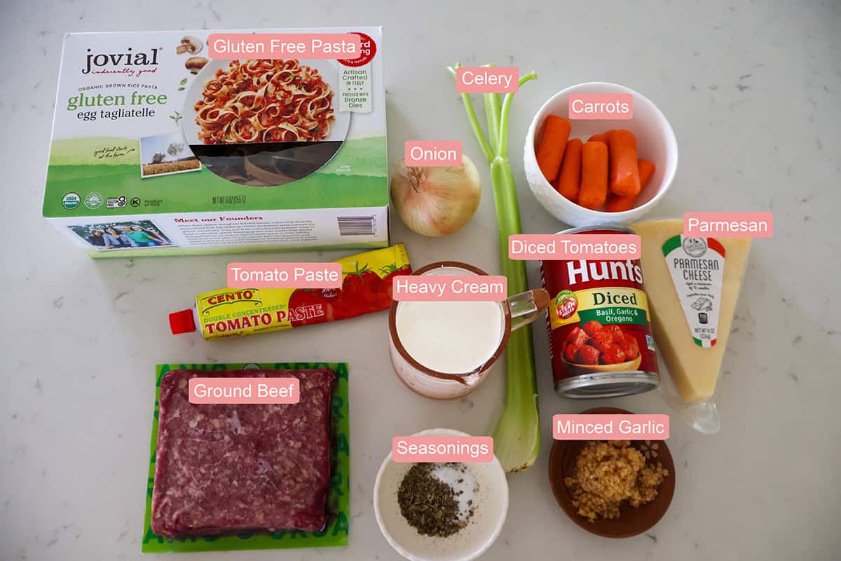 Inidividual creamy bolognese sauce ingredients on a table.