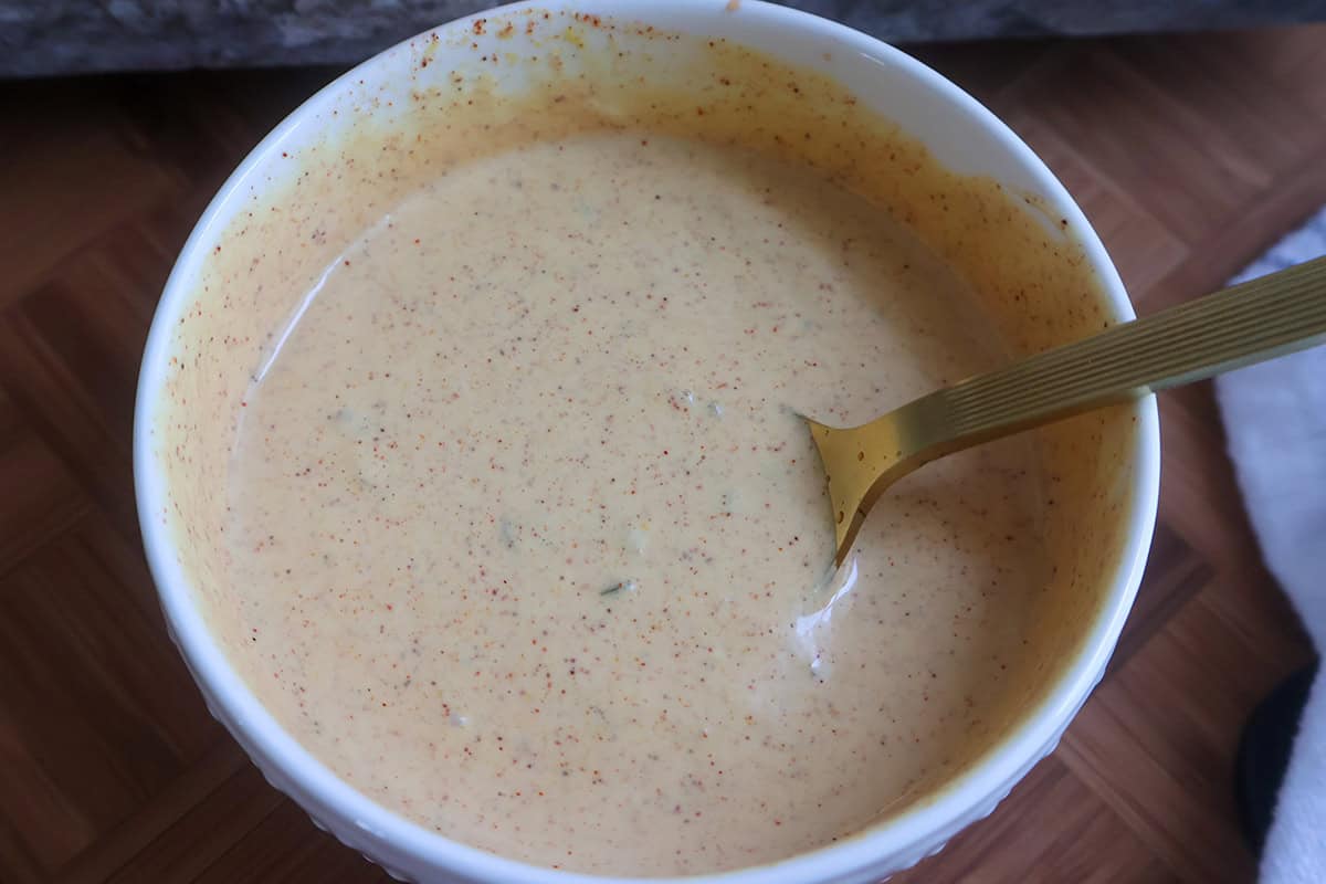 A white bolw full of Big Mac sauce.