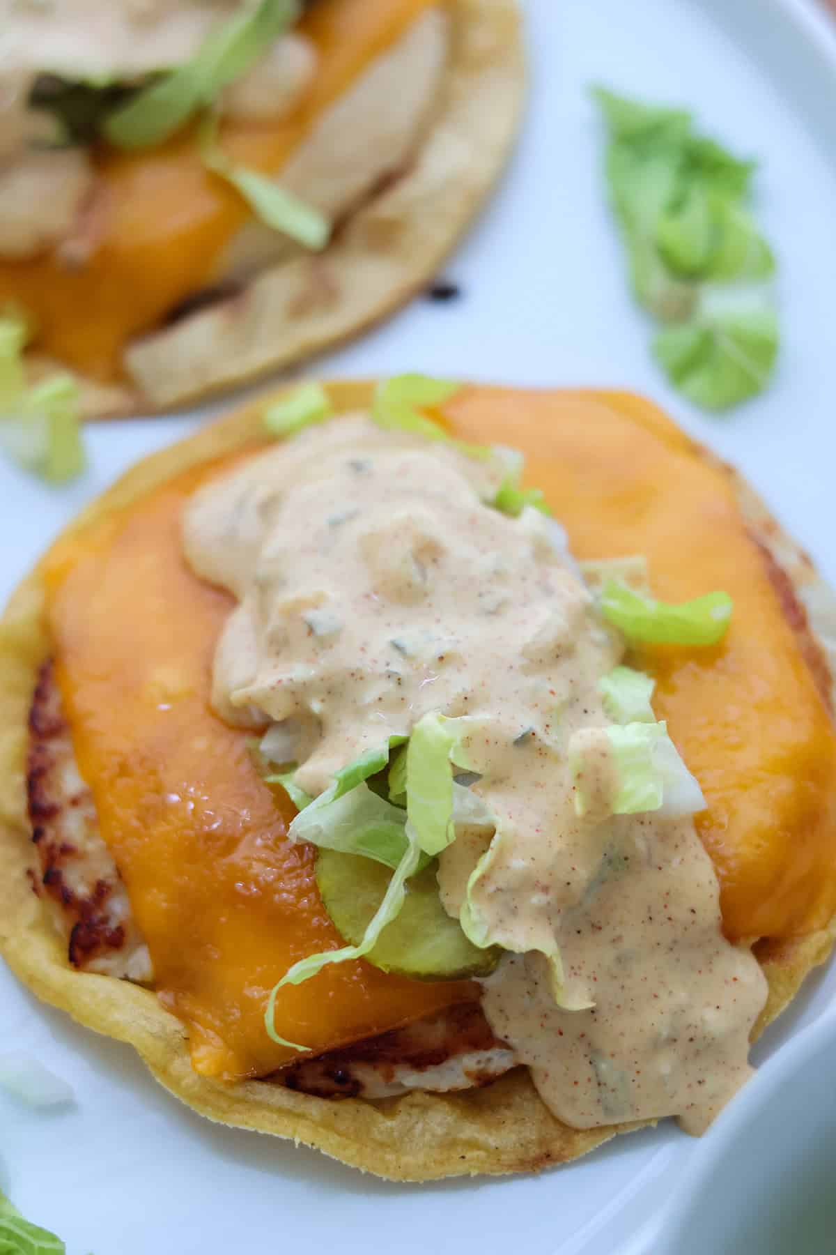 A smash burger taco topped with cheese and Big Mac sauce.