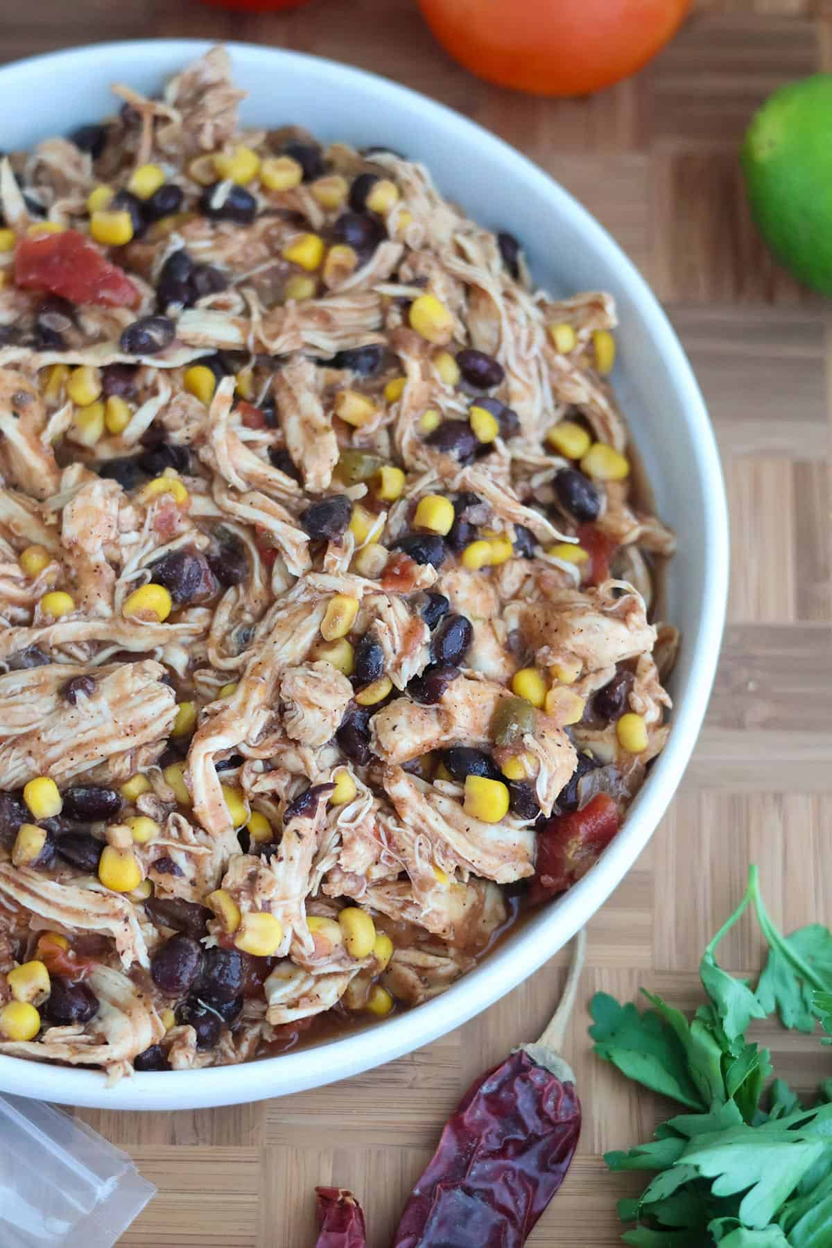 A white bowl filled with shredded Mexican chicken.