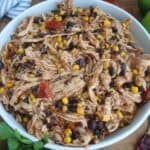 Mexican chicken with beans and corn in a white bowl.
