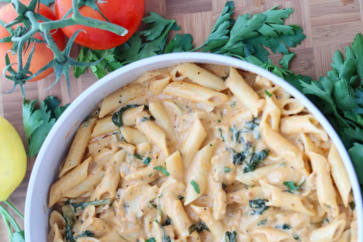 A while skillet filled with sour cream chicken and spinach pasta.
