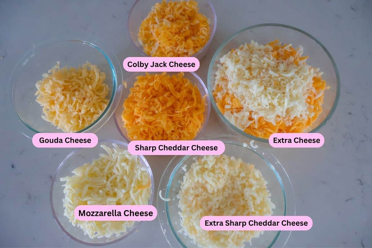 Six bowls of shredded cheese labeled on the counter.