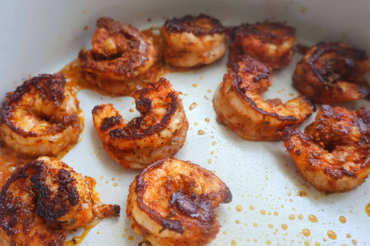 Shrimp cooking in a pan on the stove.