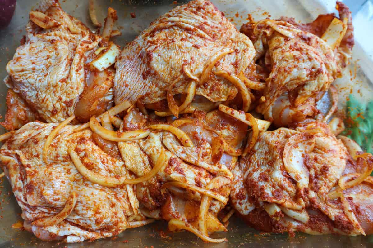 BBQ sauce, honey, brown sugar, and minced garlic being stirred together in a saucepan