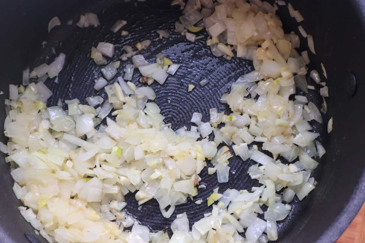 Diced onion sautéing in a large pot.