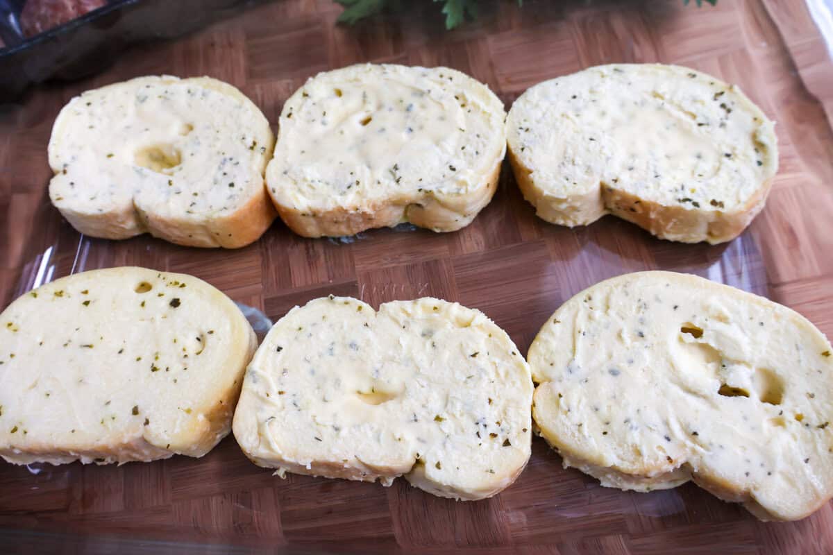 Frozen Texas Toast slices arranged on a baking sheet before baking