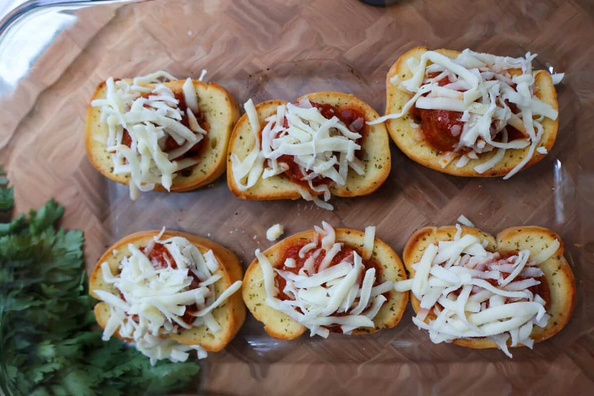 Fully assembled Texas Toast meatball melts topped with mozzarella before the final bake