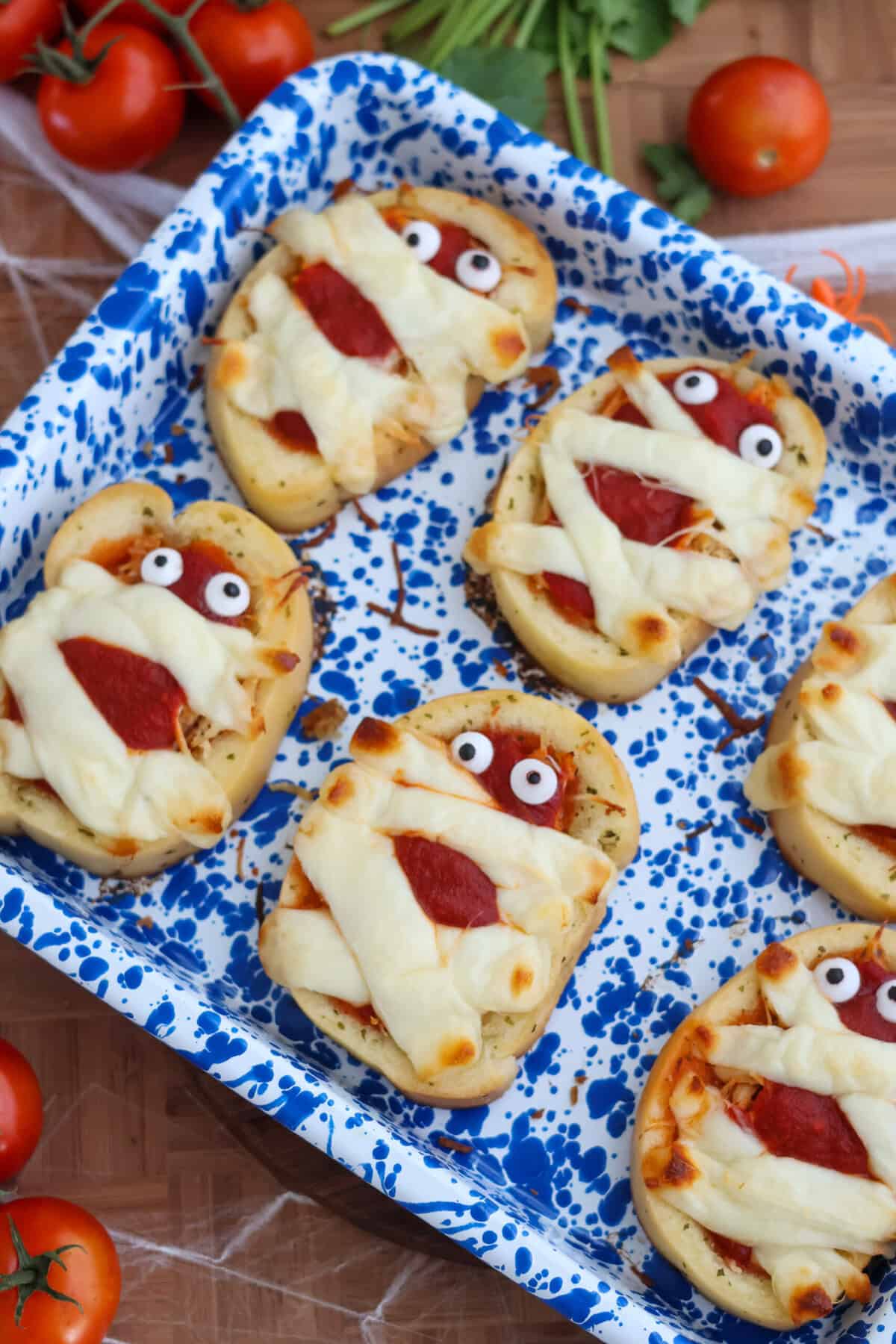 Close-up of chicken parmesan mummy garlic bread with googly eyes