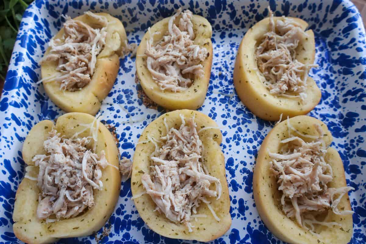 Shredded rotisserie chicken added to the wells of the Texas toast