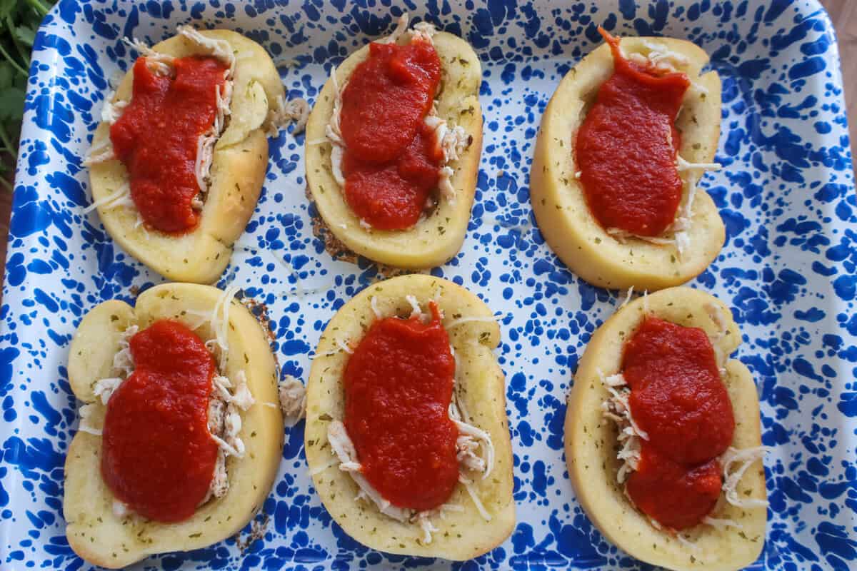 Marinara sauce spooned over the chicken on each slice of Texas toast