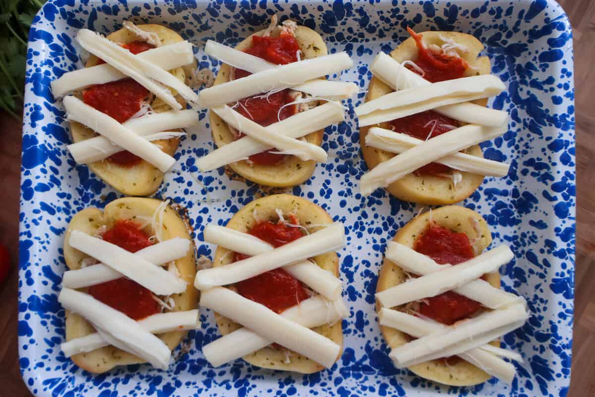 Mozzarella cheese strips crossed over Texas toast to look like mummy wrappings