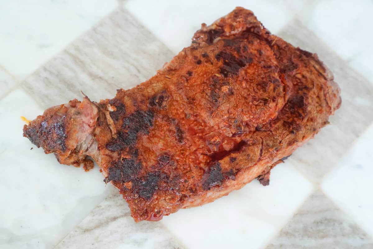 Seared blackened ribeye steak for surf and turf pasta