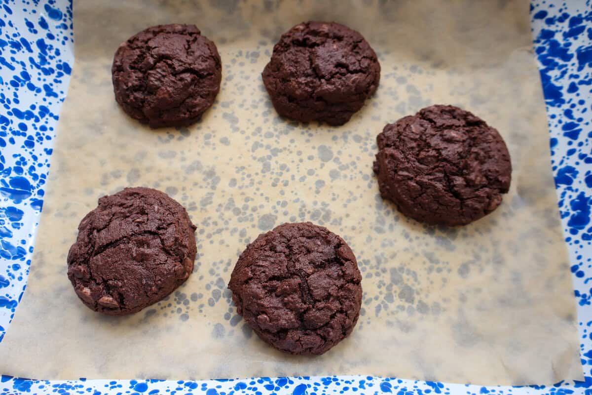 Baked chocolate cookies on parchment paper before decorating