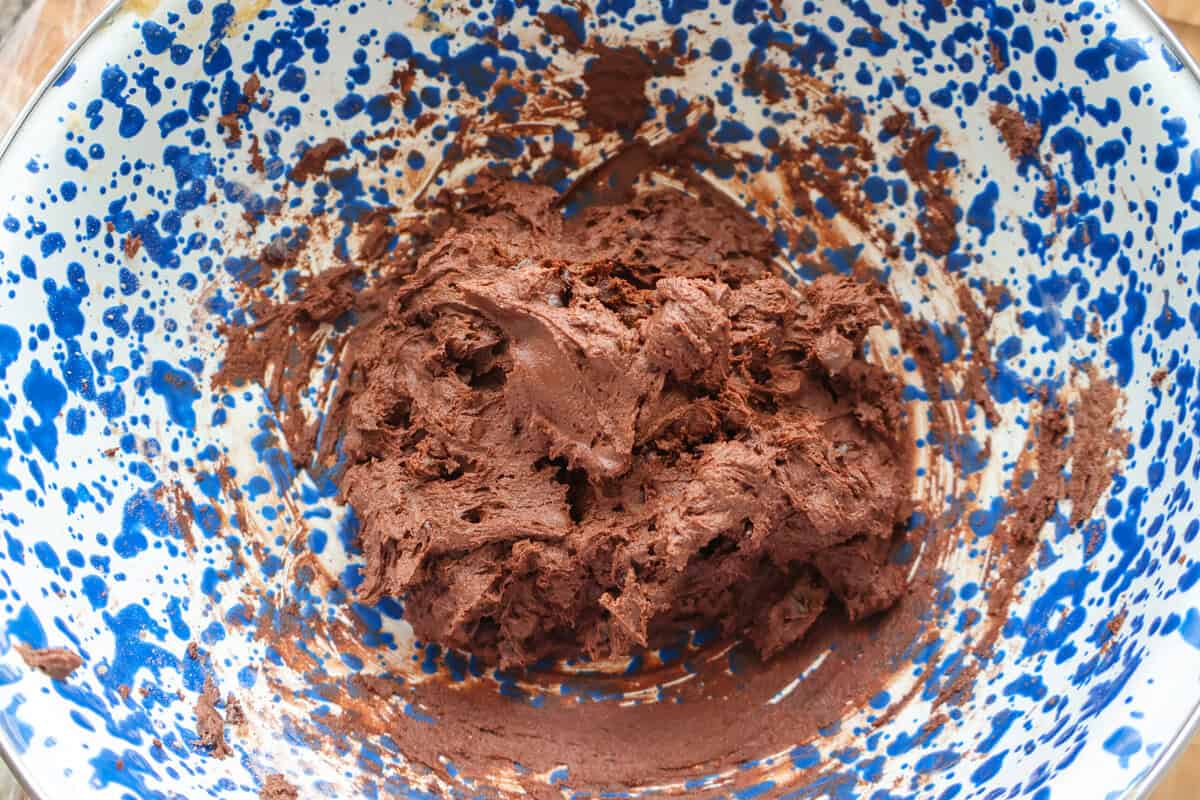 Chocolate cookie dough for spider web cookies in a mixing bowl